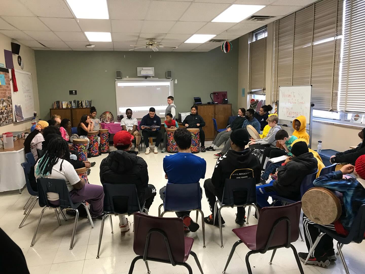 Group mentorship circle with Carlos and volunteers at Freedom Schools Cedar Rapids